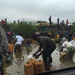 Nigerians Struggle To Scoop Fuel From A Tanker That Spilled Its Content In Lagos (VIDEO)  