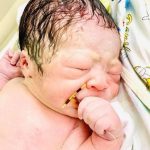 Newborn Baby Seen Holding Contraceptive That Failed To Stop His Pregnancy [PHOTOS]  